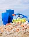 Mask,towel seashells and tube against blue sky Royalty Free Stock Photo