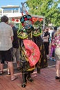 Masked Chinese dancer in ornate robe