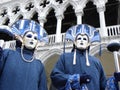 Masked couple in blue costumes at carnival