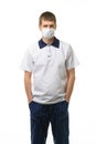 Masked doctor thrust his hands into pockets isolated on white