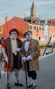 Masked and dressed up men posing on the street