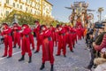 Masked figures dancing on the street with the allegorical float `Idol` in the background, Carnival of Viareggio, Italy