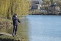 Masked fisherman catches fish following quarantine rules COVID-19