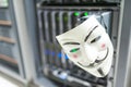 Masked Hacker in Computer Server room Concept .