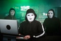 Masked Hacker is Using Computer for Organizing Massive Data Breach Attack on Corporate Servers. They& x27;re in Royalty Free Stock Photo