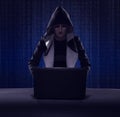 masked hacker using smartphone. Hacking the Internet.