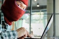 Masked hacker wearing a balaclava using laptop stealing important information data. Internet security and privacy crime concept. S Royalty Free Stock Photo