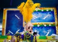 A Masked Krewe Member Checks Their Phone While Riding a Parade Float During Mardi Gras Royalty Free Stock Photo