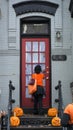 Masked Little Girl Knocking a Door Asking for Sweeties During Ha Royalty Free Stock Photo