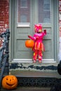 Masked Little Girl Knocking a Door Asking for Sweeties During Ha Royalty Free Stock Photo