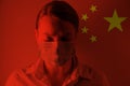 Masked man against the background of the Chinese flag Epidemic, dangerous crown virus 2020. Infection and mass disease