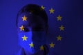 Masked man on the background of the flag of the European Union. Epidemic, dangerous crown virus of 2020. Infection and mass