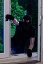 Masked man entering the house Royalty Free Stock Photo