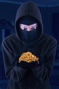 Masked man is holding stolen gold Royalty Free Stock Photo