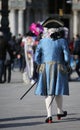 masked man with white wig and elegant blue Venetian noble dress