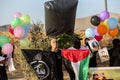 Masked Palestinians of the Popular Resistance Committees prepare incendiary balloons to be flown towards Israel