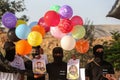 Masked Palestinians of the Popular Resistance Committees prepare incendiary balloons to be flown towards Israel