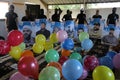 Masked Palestinians of the Popular Resistance Committees prepare incendiary balloons to be flown towards Israel