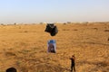 Masked Palestinians of the Popular Resistance Committees prepare incendiary balloons to be flown towards Israel