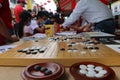 Masked people playing the Chinese Go Game, Weiqi in a street of Georgetown