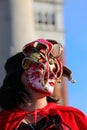 Masked person with decorated clothes and mask with unrecognizable face during the celebration of the Venice Carnival Royalty Free Stock Photo