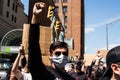 A Masked Protestor Marches and Raises His Fist at Protest for George Floyd