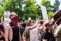 Masked Protestors Hold Up Signs at Rally for George Floyd