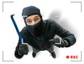 Masked robber or burglar is recorded with security hidden camera Royalty Free Stock Photo