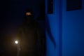 Masked robber with flashlight