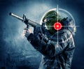 Masked terrorist man with gun and laser target on his body Royalty Free Stock Photo