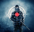 Masked terrorist man with gun and laser target on his body Royalty Free Stock Photo