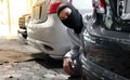 Masked thief in black balaclava trying to break into car. Criminal crime concept. Royalty Free Stock Photo