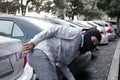 Masked thief in black balaclava trying to break into car. Criminal crime concept Royalty Free Stock Photo