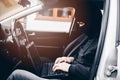 Masked thief hacker in a balaclava disarming car security systems Royalty Free Stock Photo