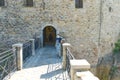 a masked tourist enters the fortress for a tour. Greece, kalabaka