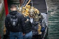 Masked tourists are sitting in gondola in Venice, Italy at winter time Royalty Free Stock Photo