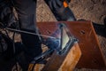 Masked welder welds metal at a construction site