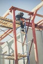 Masked welder welds metal at a construction site