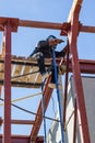 Masked welder welds metal at a construction site