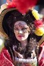 Masked woman in historical dress at Carnival of Venice