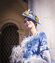 Masked woman in the Venice carnival with a blue costume