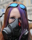 Masked Young Woman at an Anti-Cuts Protest Royalty Free Stock Photo