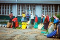 Maskeliya , Sri Lanka - 06 February, 2017: A group of tea pickers wait to have their morning harvest of leaves weighed by supervis Royalty Free Stock Photo