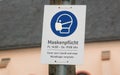 Maskenpflicht, Mask requirement, notice on mast with time indication Royalty Free Stock Photo