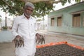 Maski, India July, 01, 2019 : Old man selling Bullocks made with mud clay, made during the festival at the start of the Monsoon in