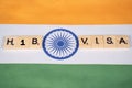 Maski, India 11,March 2021 : H1b Visa scribble tiles on Indian flag Royalty Free Stock Photo