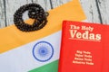 Maski,Karnataka,India - March 13,2019 :The Holy Vedas on wooden textured background with Indian flag.