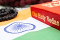 Maski,Karnataka,India - March 13,2019 :The Holy Vedas on wooden textured background with Indian flag.