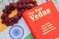 Maski,Karnataka,India - March 13,2019 :The Holy Vedas on wooden textured background with Indian flag.