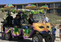 Masks, Green, Gold and Purple Decorate a Golf Cart at the Barefoot Mardi Gras Parade